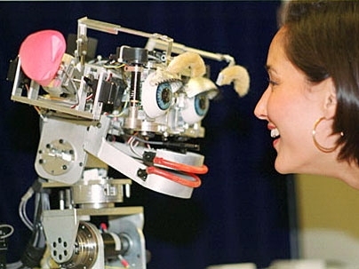 Cynthia Breazeal, MIT Media Lab, faces Kismet, a robot that mimics emotion. This photo is from 2000. <a onclick="MM_openBrWindow('coveney-kismet-enlarged.html','','width=509, height=583')">
<span onmouseover="this.className='cursorChange';">Open image gallery</span>
</a>
<noscript> <a href="coveney-kismet-enlarged.html">
<em>(no JavaScript)</em>
</a>
</noscript>