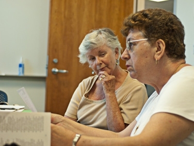 Ellen Stordy, who teaches one of the ESL classes, listens to Maria Isabel Brum, an MIT custodian originally from Portugal.