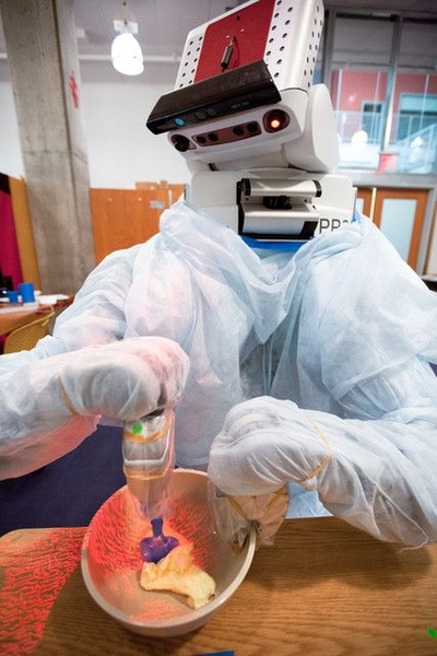 The PR2 mixes butter, one of several steps necessary for the robot to bake chocolate chip cookies.