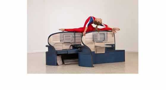 As part of the installation, gymnasts perform routines on wood replicas of business class seats from Delta and American Airlines. "We are playing with simple associations," Allora told <i>The Guardian</i> – "the relation between air travel and the way nations project themselves; the way air travel is bound up in notions of class, comfort, leisure, business. Airlines say a lot about culture and n...