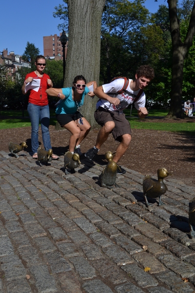 To fulfill a SimTREK photo challenge, Simmons residents and freshmen Chloe Lepert, Laura Dunphy and Brian Belding, quacked beside the famous 'Make Way for Ducklings' sculpture in Boston’s Public Garden.