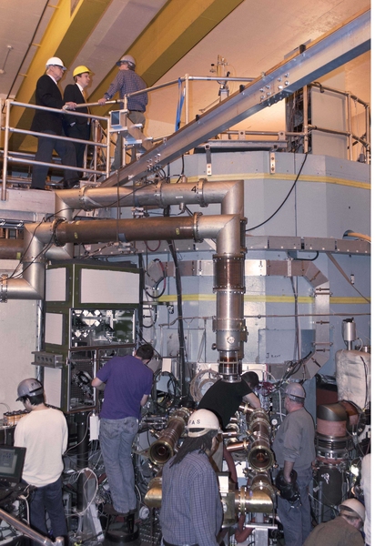 Congressman Chris Murphy (in yellow hard hat), standing at the top of the Alcator C-Mod, observed maintenance on MIT's tokamak.