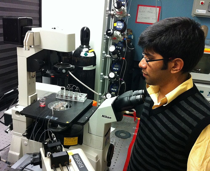 Mechanical engineering graduate student Suman Bose performs the experiment.