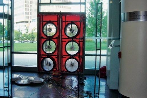 In summer 2012, MIT teamed up with outside experts to perform a blower-door test on MIT’s new Sloan building — a means of measuring the leakage of air through the building’s exterior envelope. The test involved first sealing up all external openings and then using door fans, such as those shown above, to blow in air while monitoring the pressure buildup inside the building.