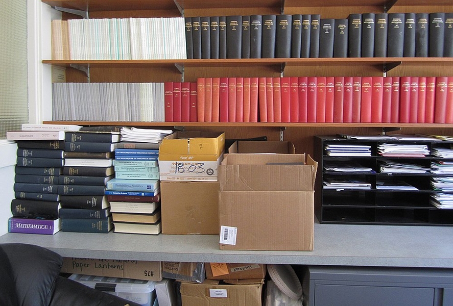 Donated mathematics texts fill the counter and shelves in the office of Sally Susnowitz, director of the Public Service Center.