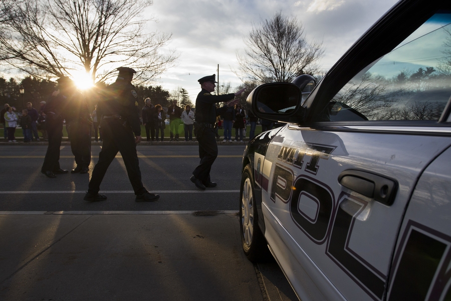 MIT Police arrive for a vigil for slain fellow officer Sean Collier at the Town Common in Wilmington, Mass.