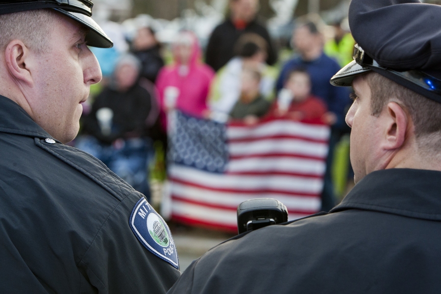 MIT Police arrive for a vigil for slain fellow officer Sean Collier at the Town Common in Wilmington, Mass.