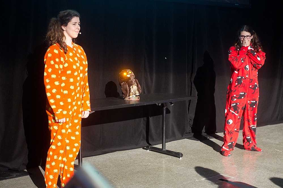 Students from Team Panda present their skit introducing a scary toy owl with glowing eyes called "Who-Who," which they described as "traumatizing toy technology."