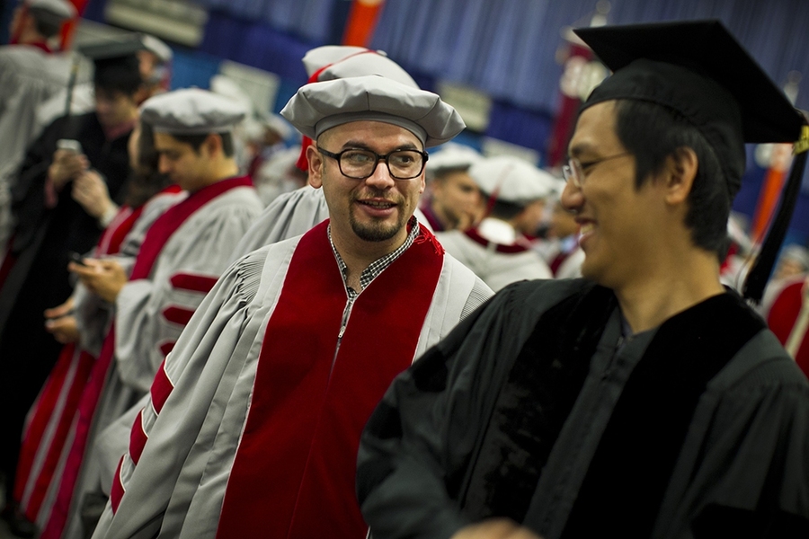 The doctoral hooding ceremony is traditionally held a day before Commencement.