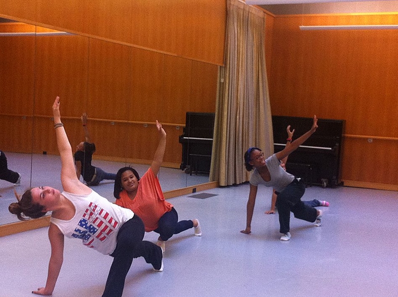 SHINE students and their mentor warm up for their dance routine.
