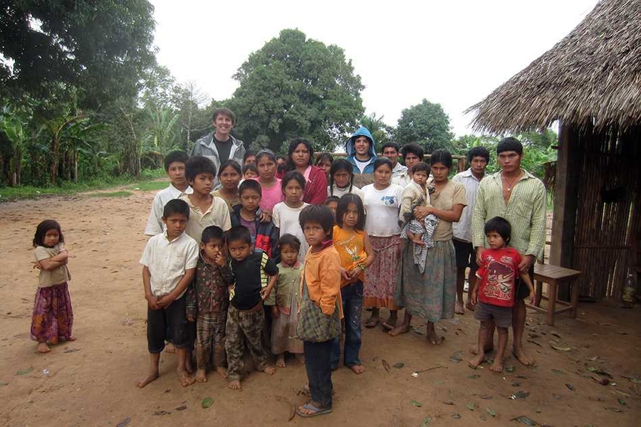 MIT professor Ted Gibson (back row, left) and graduate student Julian Jara-Ettinger (back row, center) pose with a group of Tsimane'.