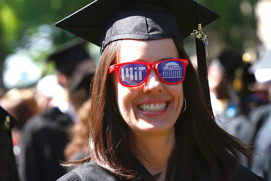 A graduating student wears sunglasses at MIT commencement.