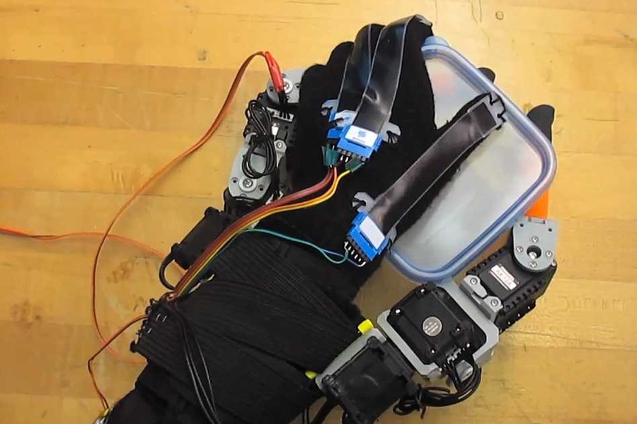 Faye Wu, a graduate student in mechanical engineering, demonstrates the "supernumerary robotic fingers" device