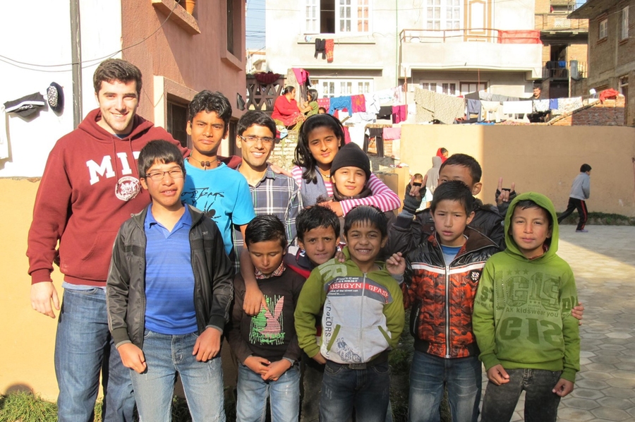 Gabriel Ravel '17 poses with Bloom Nepal students in December 2014.