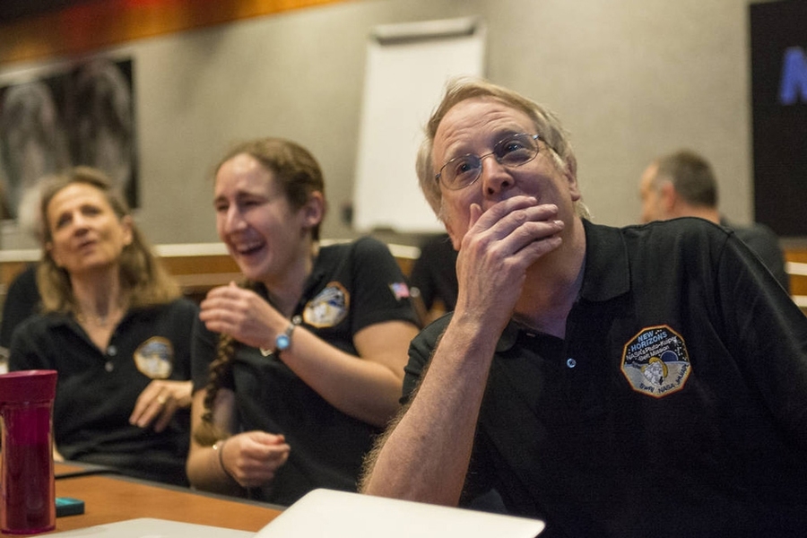 New Horizons co-investigator and MIT planetary scientist Richard Binzel (right), and Department of Earth, Atmospheric and Planetary Sciences graduate student Alissa Earle (center) react to seeing Pluto in detail for the first time.