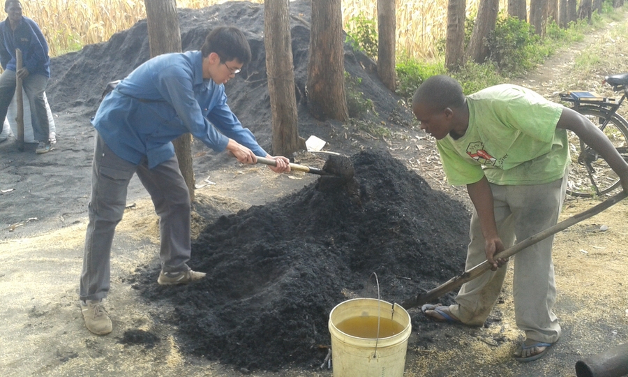 PhD student Kevin Kung, 2012 and 2014 winner, Takachar and Safi Organics, Kenya. Kung and his colleague shovel newly produced carbon-negative soil condition for rural farmers, made from local agricultural waste.