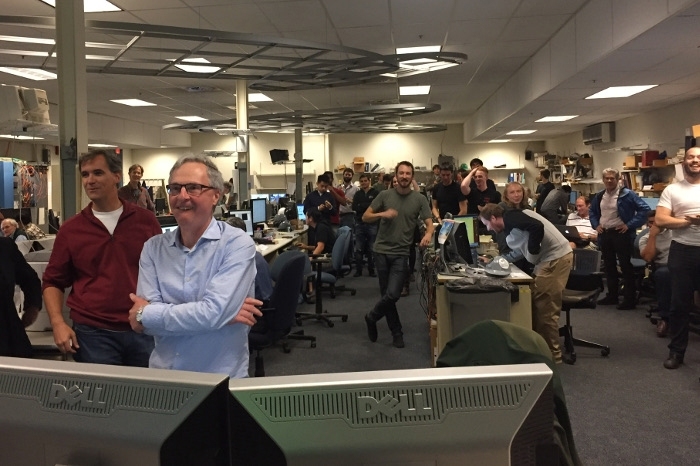 The Alcator C-Mod team celebrates the record setting plasma discharge on Alcator C-Mod the evening of its last planned day of operation.  The leader of the group, senior research scientist Earl Marmar, (front, blue shirt), performed the required tweaks to the machine operation, advised by the large interdisciplinary, interinstitutional, and international team.