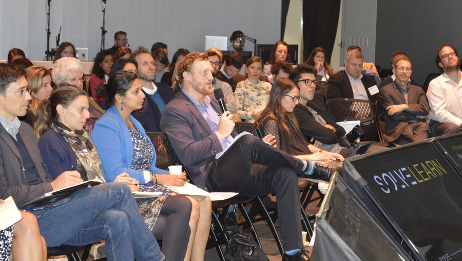 MIT Professor Admir Masic (with microphone) engages with a semifinalist during a Q&A session.