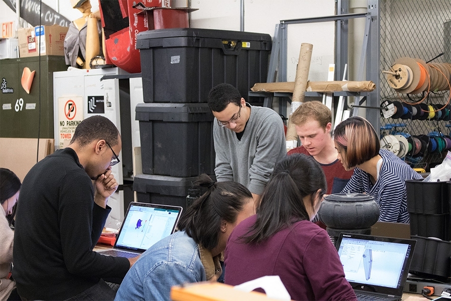 Students on MIT's Formula SAE team collaborate on components for their 2017 vehicle. Sophomore Cameron Ordone (gray shirt) discusses plans with juniors Elliot Owen and Tianye Chen. In the foreground are: (left to right) sophomores Celine Qiu and Anthony Stuart, freshman Tenzin Ukya, and sophomore Shirley Lu.