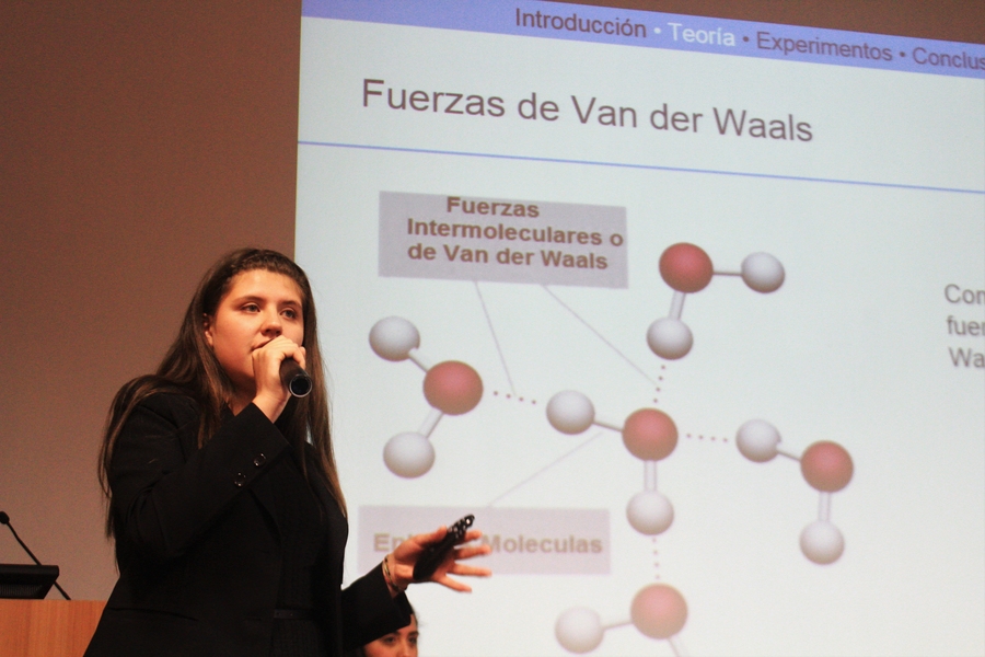 An IYPT student presents her team's project to the audience and a panel of judges during a "Physics Fight."
