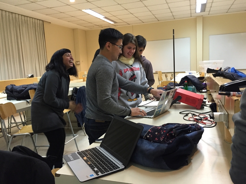 MIT civil and environmental engineering grad student Galym Saparbaiuly (center) works with a team from Complejo Educacional Consolidada on their project analyzing the dynamics of a hydrophobic droplet.