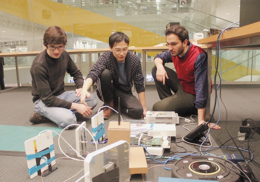 Fadel Adib (right) with postdoc Yunfei Ma (center) and graduate student Nick Selby in the Signal Kinetics group.
