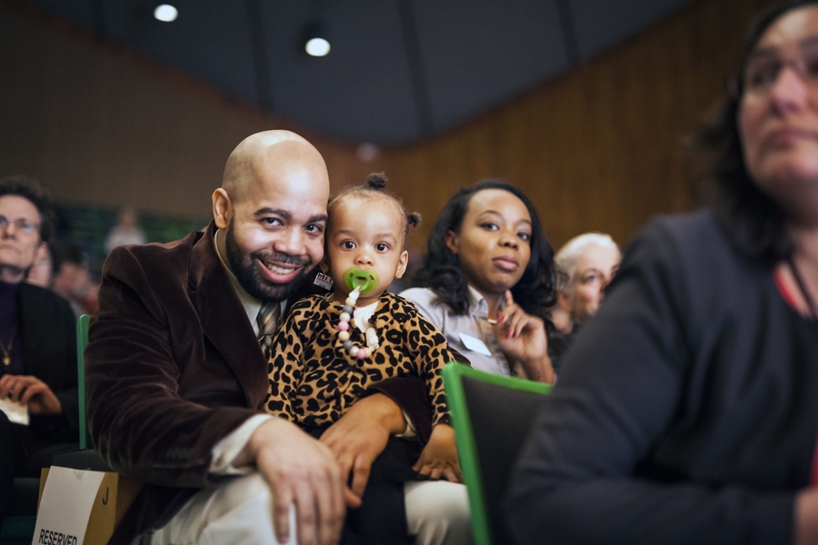 MIT Information Systems and Technology staff member Greg Walton holds his daughter during the 2017 MIT Excellence Awards and Collier Medal ceremony.