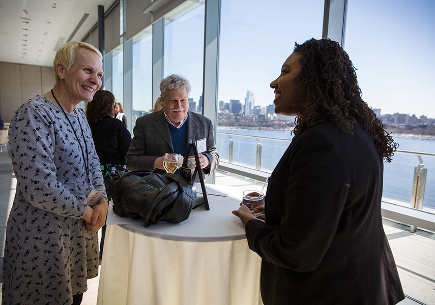 Vice President of Human Resources Lorraine A. Goffe (right) offers warm congratulations to Pamela Quick and Michael Sims, colleagues at the MIT Press.