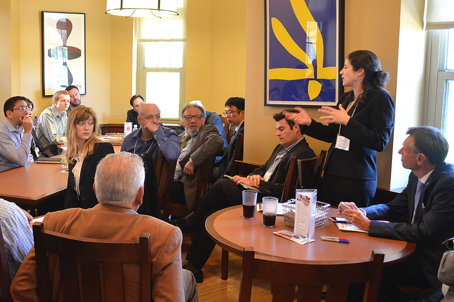Assistant professor of materials science and engineering Elsa A. Olivetti (standing, right) shares a summary of a breakout session on disposal and recovery challenges for metals and minerals with participants in the Metals and Minerals for the Environment initiative’s first public symposium on May 11 at MIT.