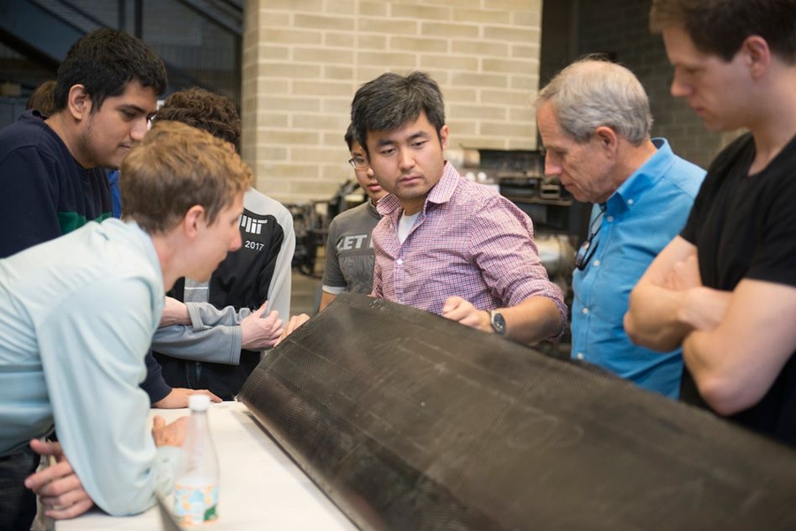 JHO team examines one of the aircraft’s carbon fiber wings, constructed by the student team in AeroAstro’s Building 33 Neumann Hangar.