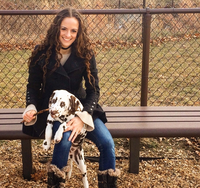 MIT grad student Elizabeth Bieler sits with her Dalmatian Hercules, who she plans to train as a therapy dog.