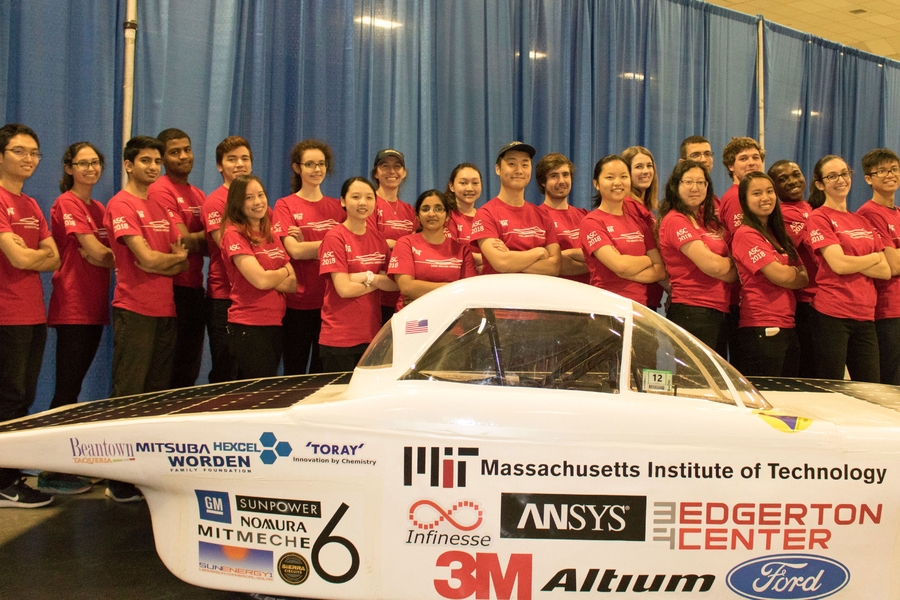 The Solar Electric Vehicle Team poses with Flux at the unveiling event held at Johnson Rink.