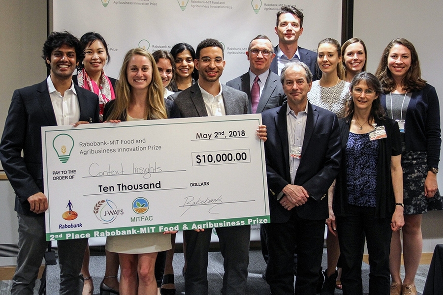 Context Insights — based on an MIT Sloan School of Management class project — won a second-place $10,000 prize. Pictured are MIT team members Tarit Rao-Chakravorti (left, holding check) and Tim Reed (right, holding check), along with prize finalists and organizers.