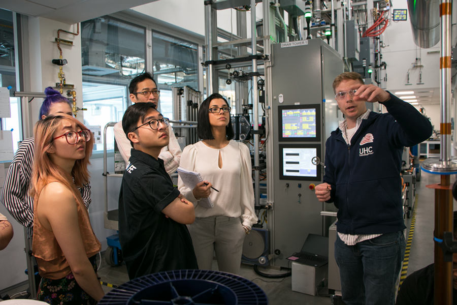 Jason Cox (right), director of fiber device technology for AFFOA, explains fiber-drawing techniques to participants in a Workshop in Advanced Functional Fabrics. Listening are (l-r, front) Melanie Wong and Calvin Zhong and (l-r, back) Erika Anderson, FIT Assistant Professor Andy Liu, and Veronica Apsan.