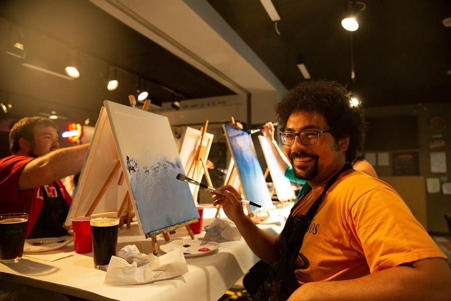 Paint Nite organizer Shaiyan Keshvari works on his creation.
