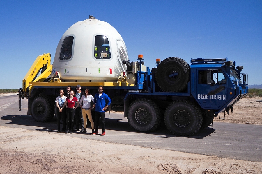 MIT Media Lab researchers (l-r) Xin Liu, Felix Kraemer, Ariel Ekblaw, Pete Dilworth, Rachel Smith, and Harpreet Sareen stand in front of the Blue Origin capsule holding their six payloads.