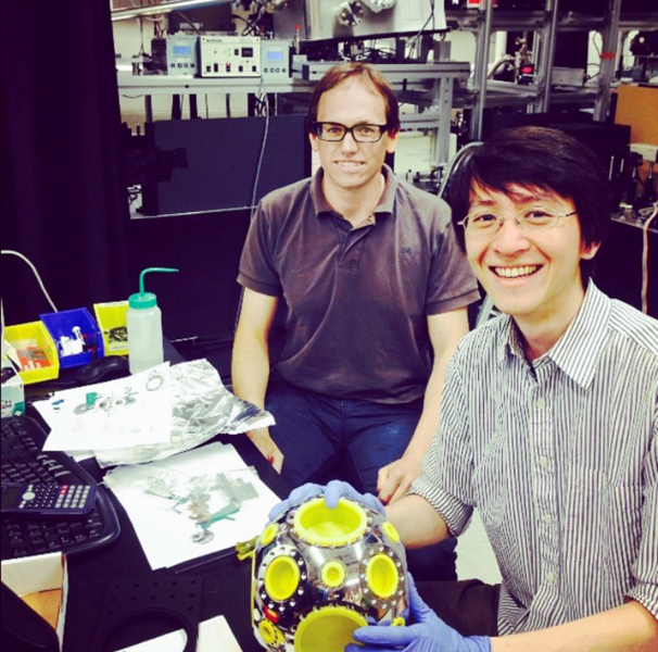 Edbert Jarvis Sie (right) and Timm Rohwer of the Gedik research group display the diagnostic chamber from their time-resolved XUV ARPES setup. The MIT researchers worked with state-of-the-art scientific equipment makers to complete their setup and push the boundary of condensed matter physics.