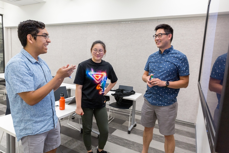 Luis Garcia discusses findings with Yeva Yin (center) and Professor David Hsu (right). Garcia and Yin, along with Grace Bryant (not pictured), worked with Hsu to analyze political spending and corresponding utility rates during their summer UROP through the MIT Energy Initiative.
