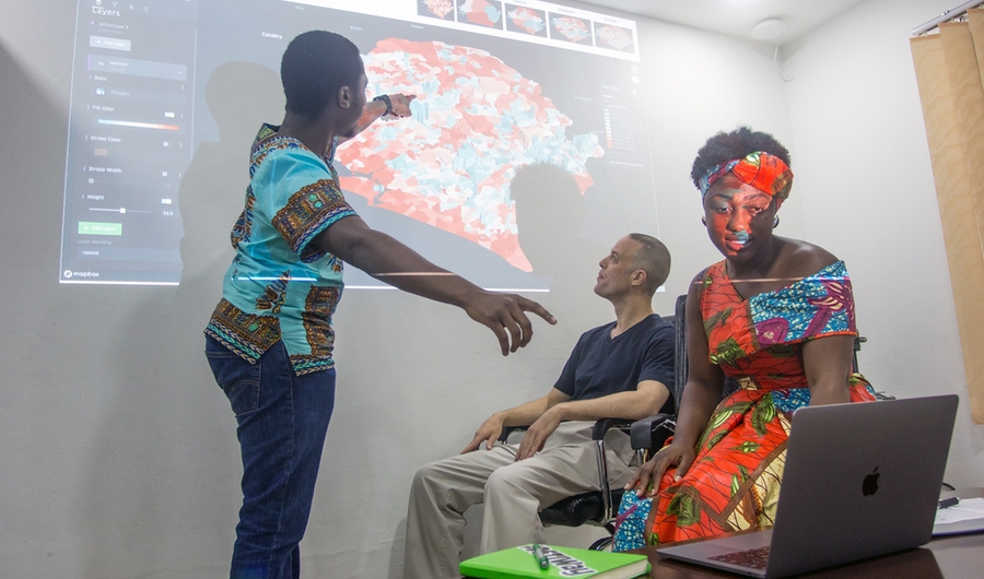 Mgcini "Keith" Phuthi ’19, a physics alumnus, works on a visualization with Mike Fabrikant, a UNICEF software developer, and Kumba Musa, a data scientist at DSTI in Sierra Leone with MISTI-Africa.