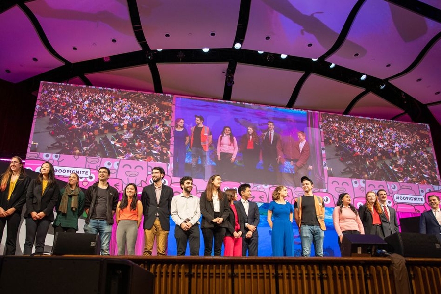 Members of each of the eight student teams take the stage for a final ovation.