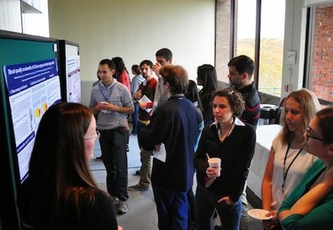 At the 2013 GCC Poster Session, PAOC&#39;s Rebecca Saari (left) presents her research on climate change policy. 
