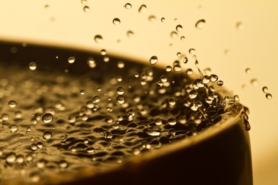 Water drops ejected from the surface of a Tibetan singing bowl. 