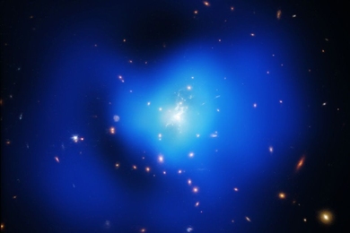 An X-ray image (in blue) with a zoom in optical image (gold and brown) showing the central galaxy of a hidden cluster, which harbors a supermassive black hole.