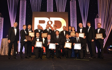 The principal researchers of  Lincoln Laboratory's 12 finalists for 2018 R&D 100 Awards pose with Lincoln Laboratory Director Eric Evans (far left). The principal researchers of the 10 winning technologies are holding their award plaques. 
