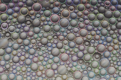 By tuning size, illumination angle, and curvature, MIT engineers can produce brilliant colors, in patterns they can predict, in otherwise transparent droplets.