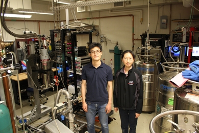 Photo of researchers Kenji Yasuda and Xirui Wang posing in the lab.