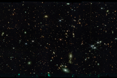 Black space with thousands of stars, tiny swirling galaxies, dozens of very bright glowing lights, and a larger swirling galaxy on bottom right.