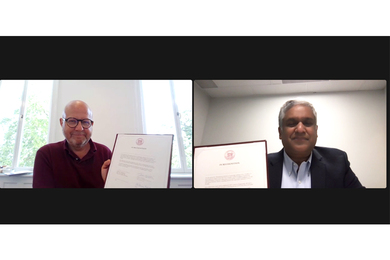 Screen capture of Thomas Senderovitz and Anantha Chandrakasan holding up versions of the signed agreement via Zoom.