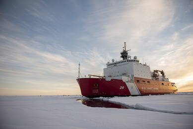 A large icebreaker ship is shown in the frozen Arctic Ocean