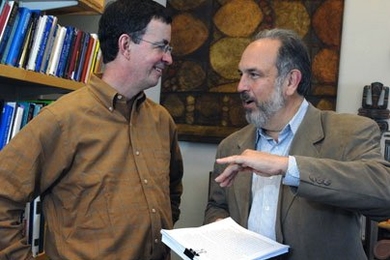 Graduate student in urban studies and planning Michael Hogan, left, and Larry Susskind, Ford Professor of Urban and Environmental Planning, discuss Hogan's thesis on government rules and renewable energy technologies.
